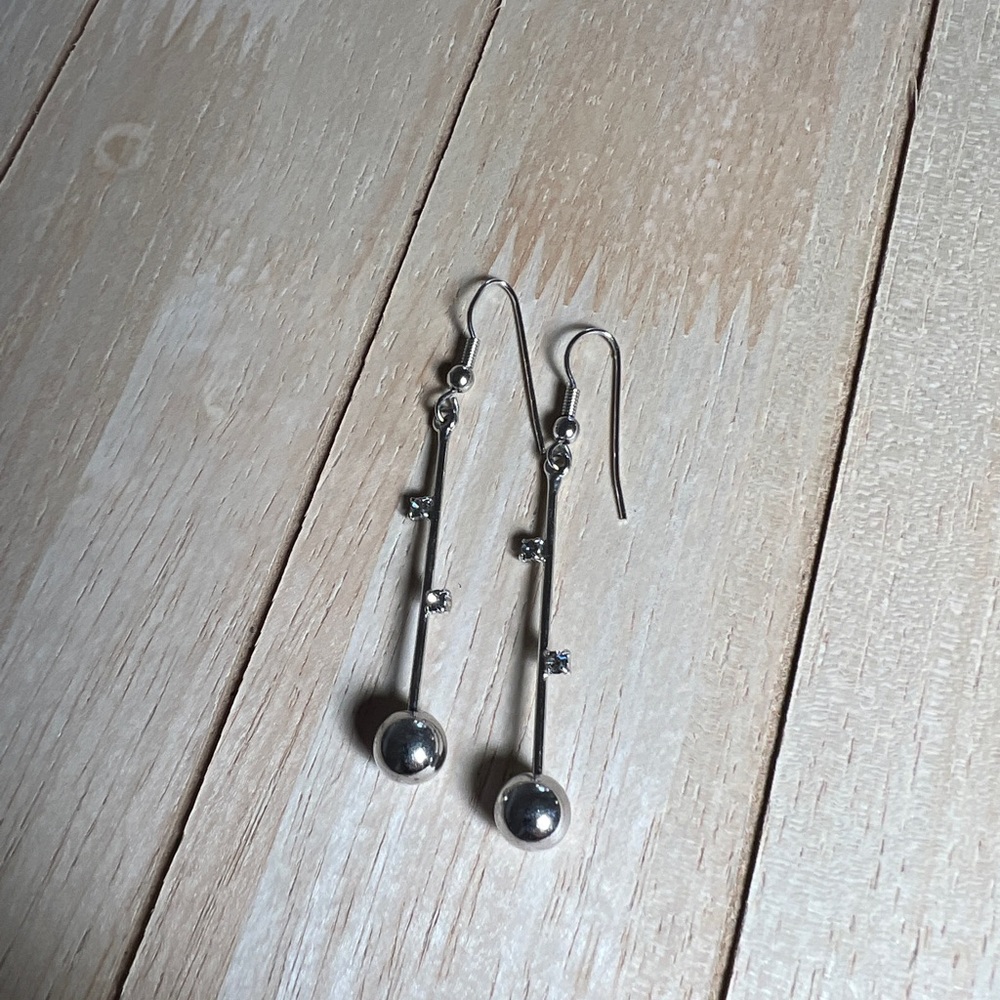 Silver dangling very light weight earring. Not real silver